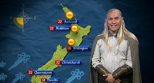 TV host Tamati Coffey in Elven themed dress presenting the summer long-range forecast in Elvish.